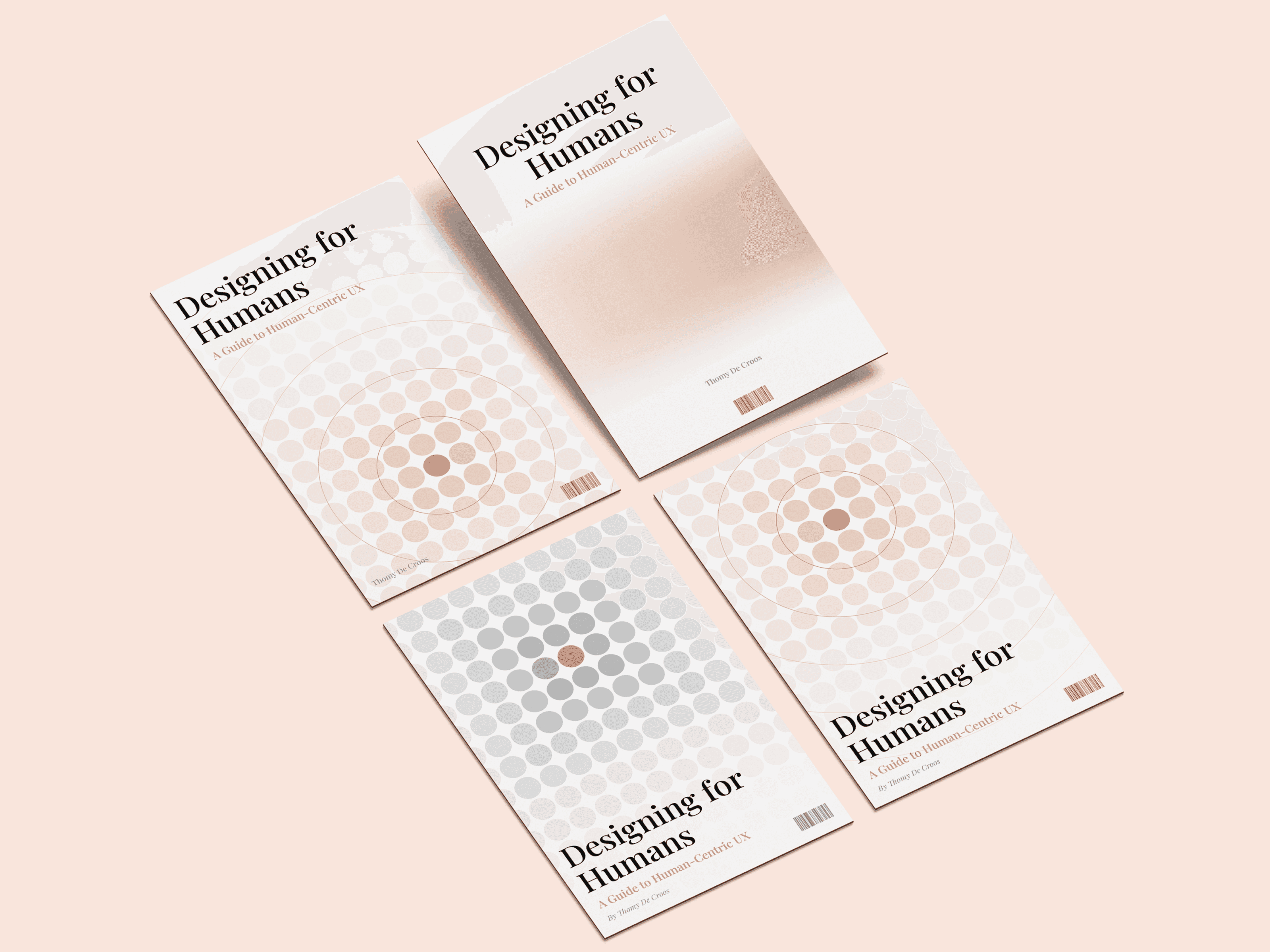 Four versions of the Designing for Humans cover laid flat on a pink background.